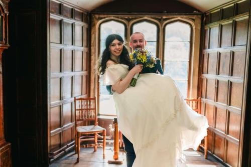 groom carrying his Bride