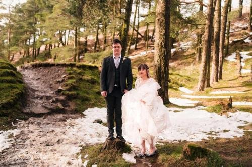 Bride and Groom in the snowy woods in Burnley Hurstwood